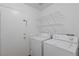Bright laundry room with washer, dryer, and shelving at 6209 Lenaking Ave, Las Vegas, NV 89122