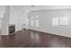 Bright living room with a fireplace, wood-look floors, plantation shutters, and high ceilings at 6209 Lenaking Ave, Las Vegas, NV 89122