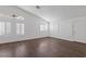 Bright living room with plantation shutters, ceiling fan, wood-look floors and ample natural light at 6209 Lenaking Ave, Las Vegas, NV 89122