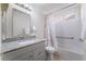 Bathroom with a granite vanity and a shower-tub combination with white tile at 6370 Canyon Vista Ct, Las Vegas, NV 89156