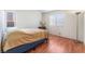 Bedroom features wood floors and a bright window with blinds for privacy at 6370 Canyon Vista Ct, Las Vegas, NV 89156