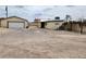 Spacious detached garage, with rear of house and access to an upper deck at 66 Lailani St, Las Vegas, NV 89110