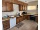 Functional kitchen featuring wood cabinetry, light countertops, and essential appliances at 66 Lailani St, Las Vegas, NV 89110