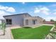 The backyard boasts green space and a covered lattice-style patio at 6741 Bonillo Dr, Las Vegas, NV 89103