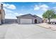 Charming single-story home with a wide driveway, grey paint, and a well-maintained yard at 6741 Bonillo Dr, Las Vegas, NV 89103