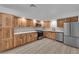 Updated kitchen features wood cabinets, stainless steel appliances and modern countertops at 6741 Bonillo Dr, Las Vegas, NV 89103