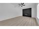 Living room featuring a sleek, modern fireplace and wood-look flooring at 6741 Bonillo Dr, Las Vegas, NV 89103