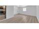 Open concept living room with wood-look flooring flowing into the kitchen at 6741 Bonillo Dr, Las Vegas, NV 89103