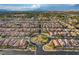 Expansive aerial view of a meticulously planned community, highlighting the neighborhood's layout and lush surroundings at 7311 Spring Flower Ave, Las Vegas, NV 89117