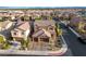 Aerial view of a neighborhood with multi-story homes, tile roofs, three-car garages, and landscaped yards at 7311 Spring Flower Ave, Las Vegas, NV 89117