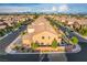 Aerial view of neighborhood with multi-story homes, red tiled roofs, landscaped yards, sidewalks, and mature trees at 7311 Spring Flower Ave, Las Vegas, NV 89117