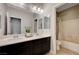 Well-lit bathroom offers double sinks, dark cabinets, and a separate toilet and shower for convenience at 7311 Spring Flower Ave, Las Vegas, NV 89117