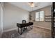 Carpeted office/bedroom with built-in shelves, a modern desk, and a bright window at 7311 Spring Flower Ave, Las Vegas, NV 89117