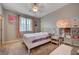 Inviting bedroom with soft lighting, a cozy bed, and shelving for stylish storage and display at 7311 Spring Flower Ave, Las Vegas, NV 89117
