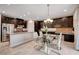 Modern dining area featuring granite countertops and tile floors adjacent to kitchen and stainless steel appliances at 7311 Spring Flower Ave, Las Vegas, NV 89117