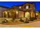 Charming two-story home features a three-car garage, stone accents, covered entry and landscaped front yard at 7311 Spring Flower Ave, Las Vegas, NV 89117