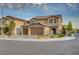 Charming two-story home featuring a three-car garage, stone accents, and well-maintained landscaping at 7311 Spring Flower Ave, Las Vegas, NV 89117