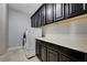 Laundry area showcases ample cabinet space, counter tops, and a modern washer and dryer unit at 7311 Spring Flower Ave, Las Vegas, NV 89117