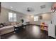 Spacious living area features modern furniture, dark wood floors, and a ceiling fan for added comfort at 7311 Spring Flower Ave, Las Vegas, NV 89117