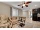 Inviting living room showcasing a comfortable sofa, ceiling fan, and neutral decor, creating a cozy atmosphere at 7311 Spring Flower Ave, Las Vegas, NV 89117