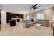 Open-concept living room features a modern kitchen, comfortable seating, and an abundance of natural light at 7311 Spring Flower Ave, Las Vegas, NV 89117