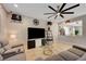 Comfortable living room featuring tile floors, ceiling fan, and a clear view of entryway through the open wall at 7311 Spring Flower Ave, Las Vegas, NV 89117