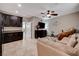Living area with cabinets, tile floors, a sofa, and a large TV, creating a comfortable and functional space at 7311 Spring Flower Ave, Las Vegas, NV 89117