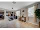 Bright living room with neutral walls, tiled flooring, large windows, and views into other living spaces at 7311 Spring Flower Ave, Las Vegas, NV 89117