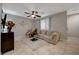 Spacious living room with tiled floors, a comfortable sofa, and a decorative cabinet, offering a cozy gathering space at 7311 Spring Flower Ave, Las Vegas, NV 89117