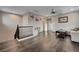 Spacious loft area with dark wood floors, a comfortable sofa, and ample light, perfect for relaxation and entertainment at 7311 Spring Flower Ave, Las Vegas, NV 89117