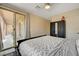 Well-lit bedroom featuring dark wood floors, a sliding glass door, and modern decor, creating a comfortable and stylish space at 7311 Spring Flower Ave, Las Vegas, NV 89117