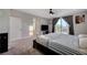 Bright bedroom boasts a sliding glass door, plush carpet, and a ceiling fan for optimal relaxation at 7311 Spring Flower Ave, Las Vegas, NV 89117