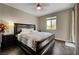 Serene bedroom with dark hardwood floors, a large bed, and soft natural light from the window, creating a restful retreat at 7311 Spring Flower Ave, Las Vegas, NV 89117