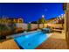 Backyard pool and spa with water features, brick pavers, landscape, and lounge area with string lights overhead at 7311 Spring Flower Ave, Las Vegas, NV 89117