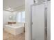 The luxurious bathroom features double vanities and a large soaking tub at 7525 Royal Crystal St, Las Vegas, NV 89149