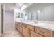 Bathroom featuring double sink vanity, tile flooring, and ample mirror space at 7525 Royal Crystal St, Las Vegas, NV 89149