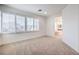 Bright bedroom features shuttered windows and leads to the en suite bathroom at 7525 Royal Crystal St, Las Vegas, NV 89149