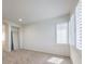A carpeted bedroom with shuttered windows and view through an archway to another room at 7525 Royal Crystal St, Las Vegas, NV 89149