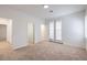 Spacious bedroom with carpet flooring, white walls, double doors leading to balcony and ensuite bathroom at 7525 Royal Crystal St, Las Vegas, NV 89149