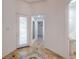 Bright foyer features decorative tile flooring, white door with glass inserts, and views into adjacent living spaces at 7525 Royal Crystal St, Las Vegas, NV 89149