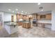 A gourmet kitchen with an island, tile floor, and wooden cabinets with modern appliances at 7525 Royal Crystal St, Las Vegas, NV 89149