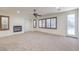 Bright living room with fireplace, ceiling fan, and access to the outdoor pool area at 7525 Royal Crystal St, Las Vegas, NV 89149
