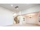 Open-concept living area with winding staircase and chandelier at 7525 Royal Crystal St, Las Vegas, NV 89149