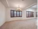 Spacious living room features large windows with wood shutters and a decorative chandelier at 7525 Royal Crystal St, Las Vegas, NV 89149