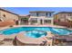 Pool and spa in backyard surrounded by stone tile, and desert landscaping at 7525 Royal Crystal St, Las Vegas, NV 89149