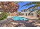 Backyard pool and spa with desert landscaping around a stucco two-story home at 7525 Royal Crystal St, Las Vegas, NV 89149