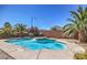Backyard pool with rock waterfall feature surrounded by desert landscaping at 7525 Royal Crystal St, Las Vegas, NV 89149