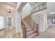 Elegant curved staircase with wrought iron railings and plush carpeting at 7525 Royal Crystal St, Las Vegas, NV 89149