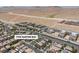Overhead shot of a suburban setting, featuring cohesive architectural styles, street design, and desert terrain at 7775 Santos Bay Ct, Las Vegas, NV 89179