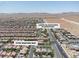 Wide-angle view of a residential zone highlighting community integration, standardized homes, streets, and adjacent desert landscapes at 7775 Santos Bay Ct, Las Vegas, NV 89179